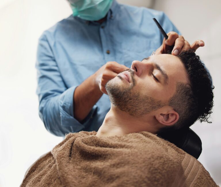 Getting his hair and beard trimmed