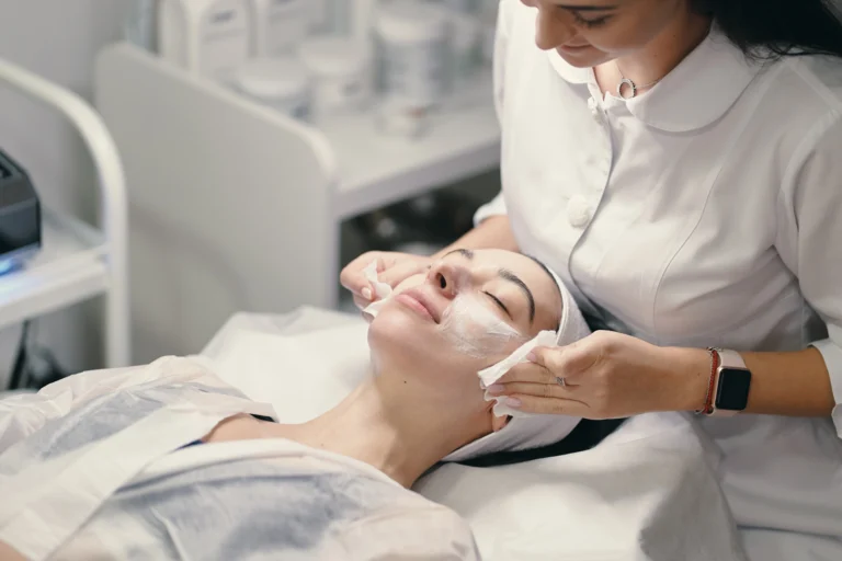 female cosmetologist making facial treatment beautiful woma